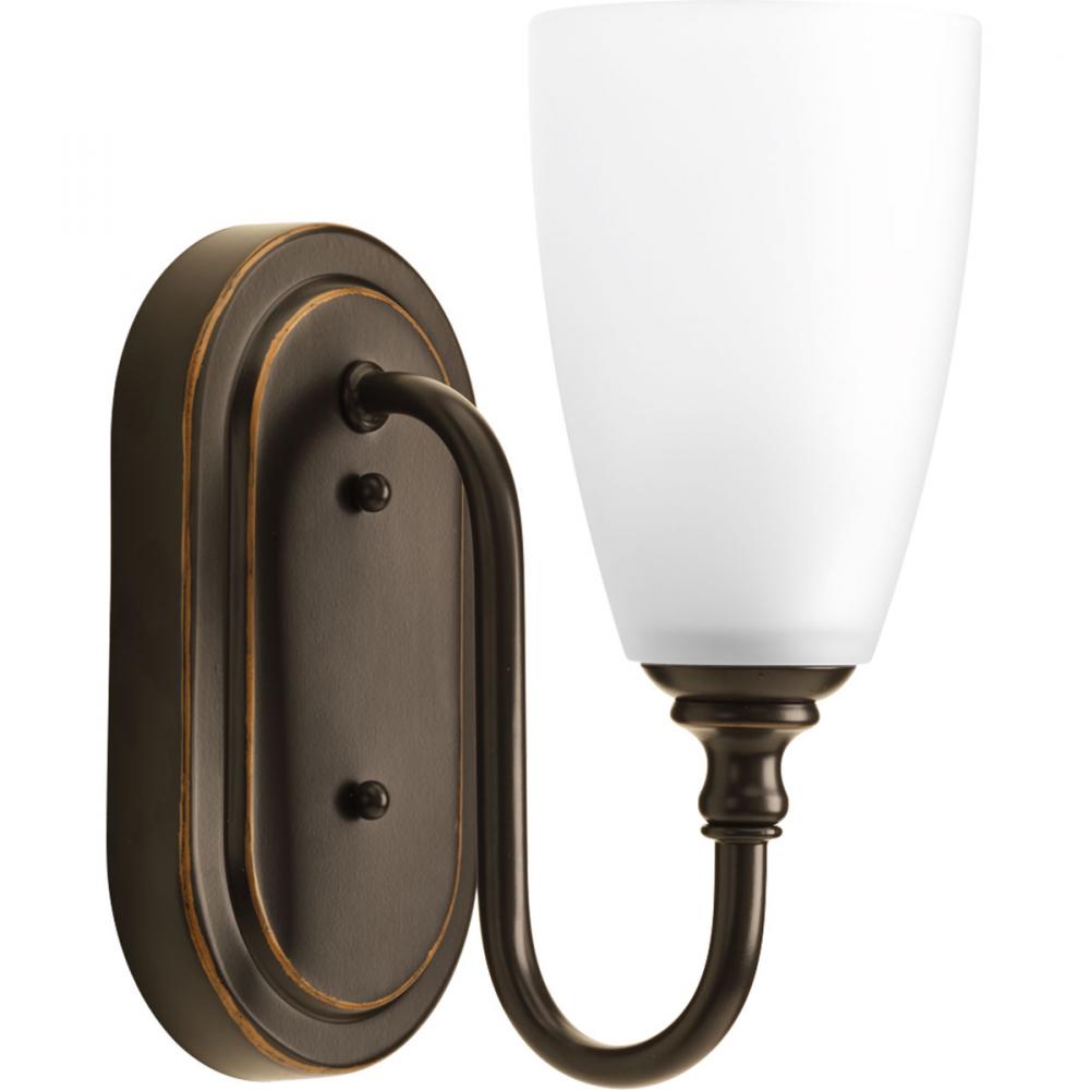 One-light bath and vanity fixture finished in antique bronze with an etched glass shade. Part of the