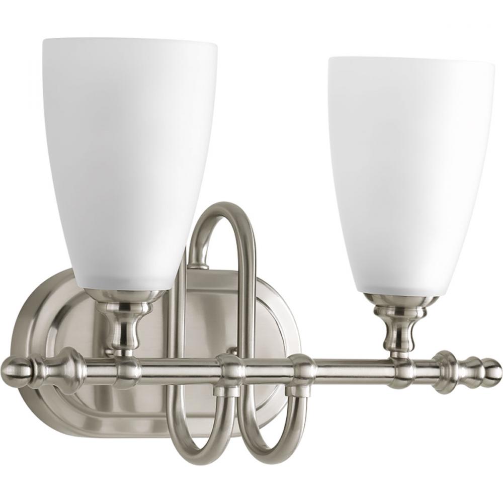 Two-light bath and vanity fixture finshed in brushed nickel with an etched glass shade. Part of the